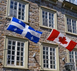 Fototapeta premium Flags of Canada and Quebec province in Quebec City, Canada