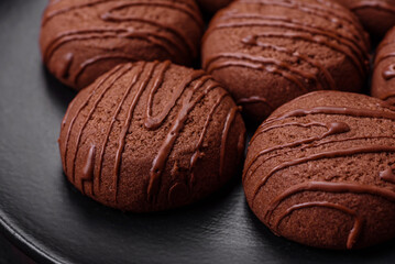 Delicious sweet chocolate cookies on a black ceramic plate