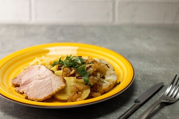 pork meat with potato dumplings and pickled cabbage served with roasted onion