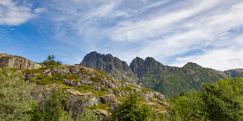 Fototapeta na wymiar Mountain peaks behind hilltops in Lofoten islands in Norway in summer