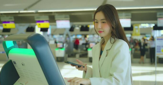 Asian woman look and search her fight at airport terminal.
