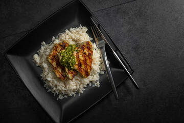 grilled poultry meat with pesto served with rice