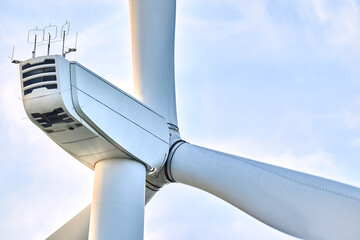 Close-up low angle view of wind turbine against blue sky Windmill for electric power production