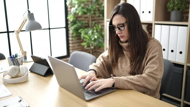 Beautiful hispanic woman business worker using laptop working at office