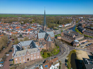 This aerial drone photo shows the city center of Woerden in Zuid-Holland, the Netherlands. There is a large church in the center and many typical dutch houses. 