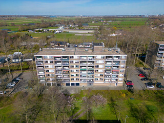 This aerial drone photo shows a typical dutch apartment building in a residential area in the Netherlands.