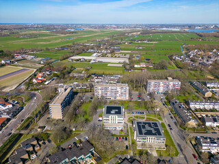 This aerial drone photo shows a typical dutch apartment building in a residential area in the Netherlands.