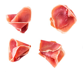Curled Slices of Delicious Prosciutto isolated on white background top view.