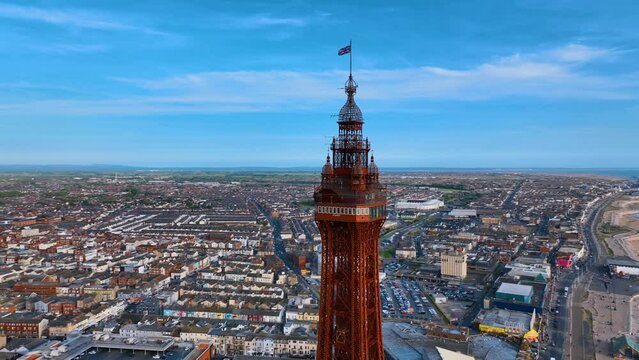 Aerial footage,of the famous Blackpool Tower and beach from the sky on a beautiful Summers day on one of Great Britains most popular holiday destinations, tourist attractions by the sea