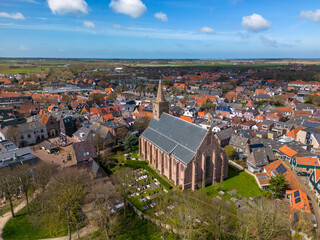 This aerial drone photo shows the old city center of Den Burg with a beautiful church. Den Burg is the capital of Texel, an island in the Wadden Sea, the Netherlands. 
