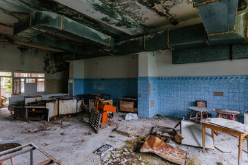 Abandoned and ruined kitchen of closed factory canteen or restaurant
