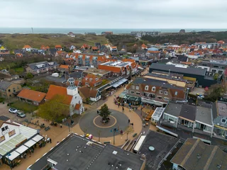 Schilderijen op glas This aerial drone photo shows the city center of the small town de Koog in Texel. You can see a church and square. Texel is an island in the wadden sea, the Netherlands. © robin