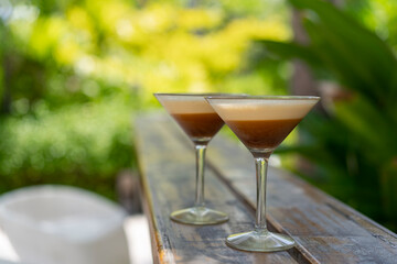 Two glasses of espresso martini at a beach bar in the Maldives