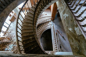 Top view of old vintage decorated spiral staircase in abandoned mansion
