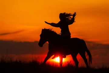 Foto op Canvas silhouette of a woman riding a horse © michal