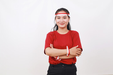 Young Indonesian girl celebrate indonesia independence day. Standing with folded hands against white