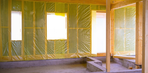 Frame house under construction. Remodeling of the cottage. Waterproofing of the house from inside.