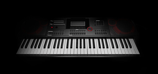 Keyboard synthesizer on a dark background. Electric piano close-up.