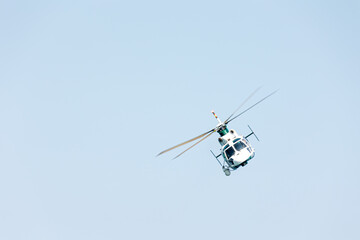 Front view of a Spanish military police helicopter doing control of the frontiers of the country over the sea on a summer day