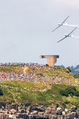 Gijon Air Show Festival in Asturias, with two airplanes flying through a mountain full of people...