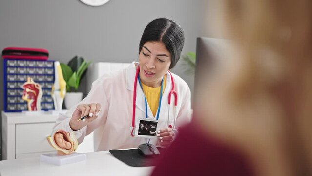Young beautiful hispanic woman gynecologist having gynecology consultation with patient at clinic