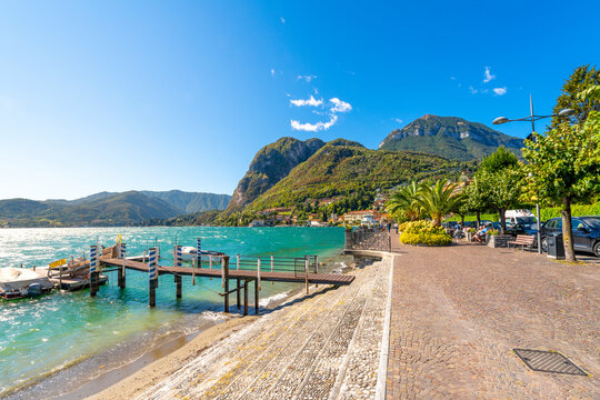 A small boat dock along the lakefront promenade at the picturesque town of Menaggio, Italy, on the shores of Lake Como in Northern Italy.	