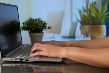 Person working at computer with out-of-focus office background