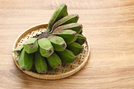 Raw Kepok Banana (Pisang Kepok) on wooden table
