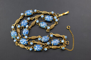 Blue crystal gold link bracelet, unique vintage jewelry background, old jewelry concept, promotional photo for an online jewellery store