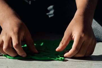 Colorful Creativity: Capturing the Joy as Children's Hands Play with Colored Dough in a Vibrant Photograph