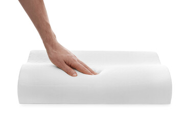Man touching orthopedic memory foam pillow on white background, closeup