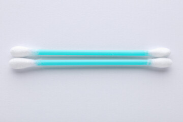 Clean cotton buds on white background, top view. Hygienic accessory