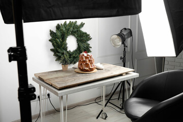 Professional equipment and Christmas composition with Pandoro cake on wooden table in studio. Food photography