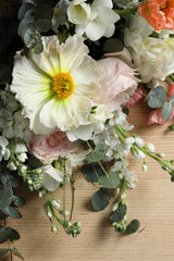 Bouquet of beautiful flowers on wooden table, closeup
