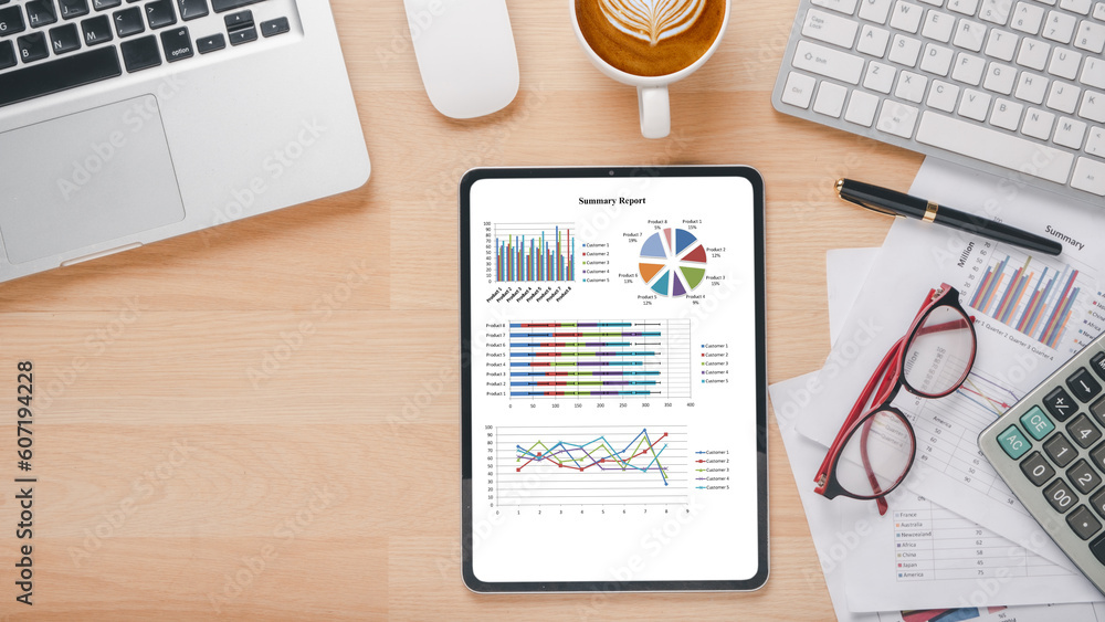 Poster tablet with charts and reports on office desk workplace. top view flat lay..