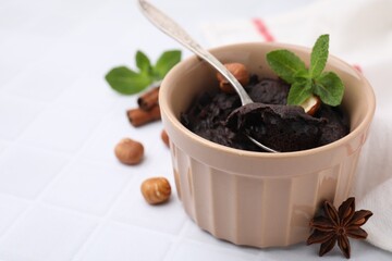 Tasty chocolate pie on white tiled table, space for text. Microwave cake recipe