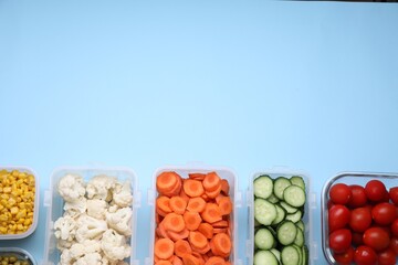 Plastic and glass containers with different fresh products on light blue background, flat lay. Space for text