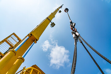 The hydraulic cylinders of an offshore oil rig crane are using four strong slings to lift large...
