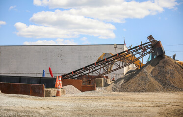 Construction sites with metal, wood, and big machinery represent progress, development, craftsmanship, teamwork, and transformation