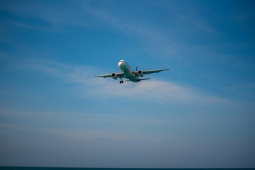 Fototapeta na wymiar A plane is landing and blue sky.