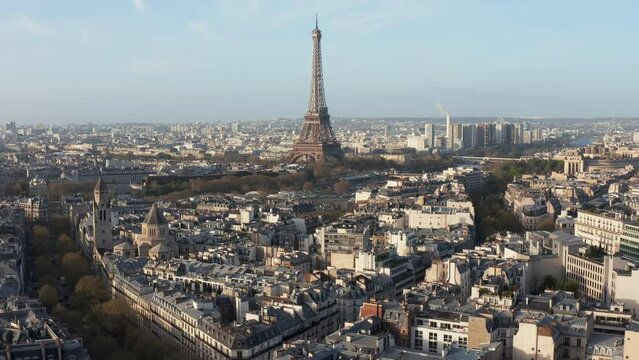 Aerial above old town Paris buildings towards Eiffel Tower. Morning soft light