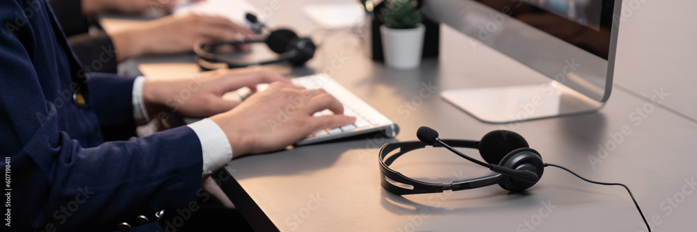 Aufkleber panorama focus headset on call center workspace desk with blur background of operator team or telesa