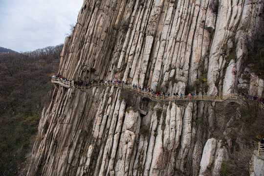 LUOYANG, CHINA - APRIL 10, 2021: Trail and cliffs in Songshan Mountain, China. Songshan is the tallest of the 5 sacred mountains of China dedicated to Taoism and stand above the famous Shaolin temple