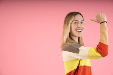 Young woman in profile pointing behind her