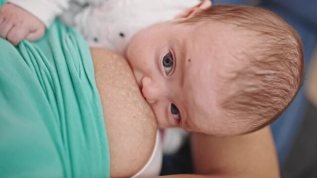Caucasian baby girl breastfeeding