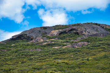 Fototapeta na wymiar Eroded granite rocks and coastal vegetation along the Coastal Track in Cape Le Grand National Park, Esperance, Western Australia 