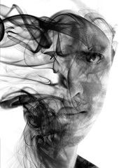 Double exposure black and white portrait of a man's face gazing with one eye