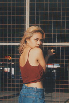 Woman in red top turning back to face camera