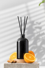 Black glass diffuser with the scent of cinnamon, orange. Perfumes for the room