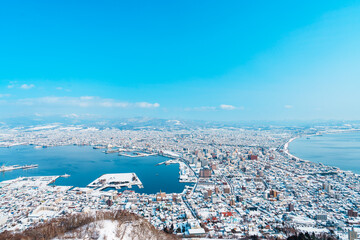 Naklejka premium Beautiful landscape and cityscape from Hakodate Mountain with Snow in winter season. landmark and popular for attractions in Hokkaido, Japan.Travel and Vacation concept